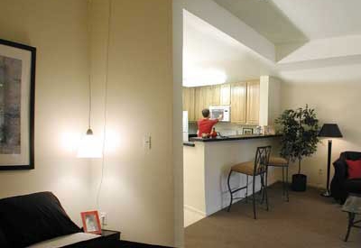 A studio unit view of the kitchen from the bedroom area at Lenzen Square in San Jose, California.