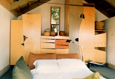 Custom stained-plywood wardrobe in the master bedroom at Revenge of the Stuccoids in Berkeley, California.