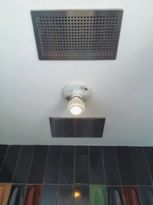 Air exhaust and LED light fixture in the bathroom at Zero Cottage in San Francisco.