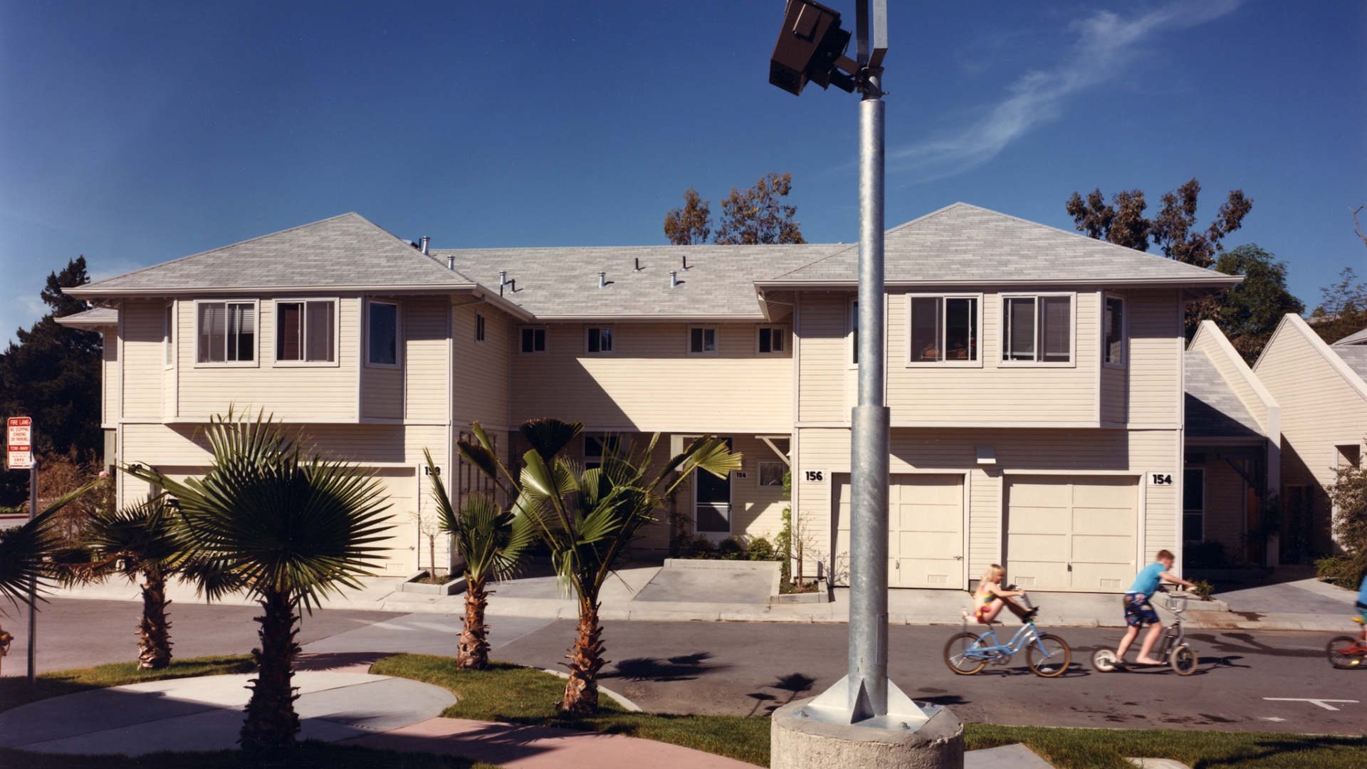 Exterior street view of two duplexs at Meadow Court in San Mateo, California.