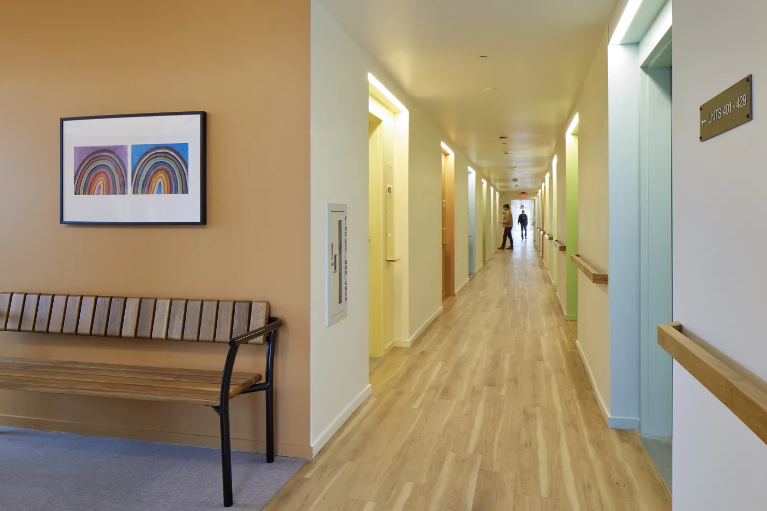 Resident hallway at Tahanan Supportive Housing painted in different colors.