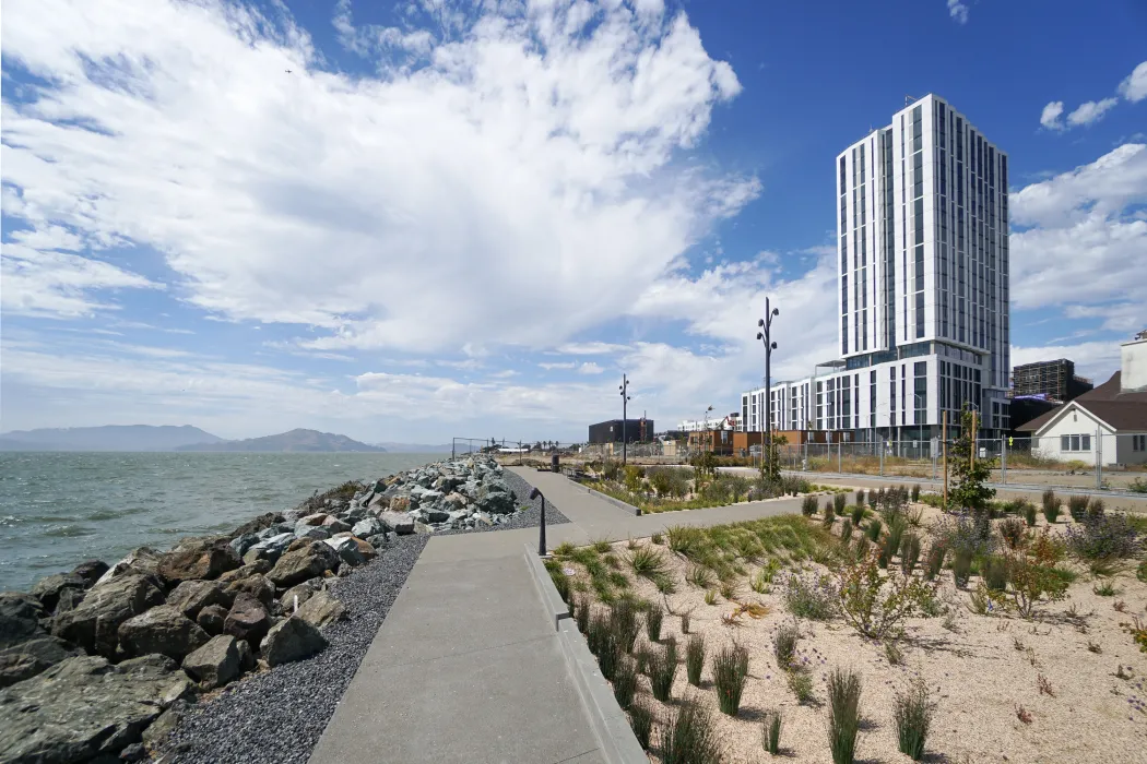 Exterior view of Isle House on Treasure Island with the San Francisco bay in the background.