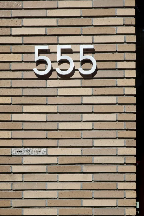 Exterior view of the tiles and adress—555 on the building.