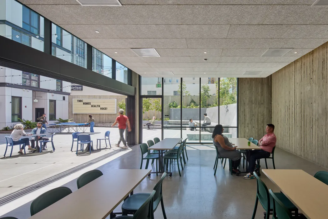 Community lounge opening out into the courtyard at 555 Larkin in San Francisco.