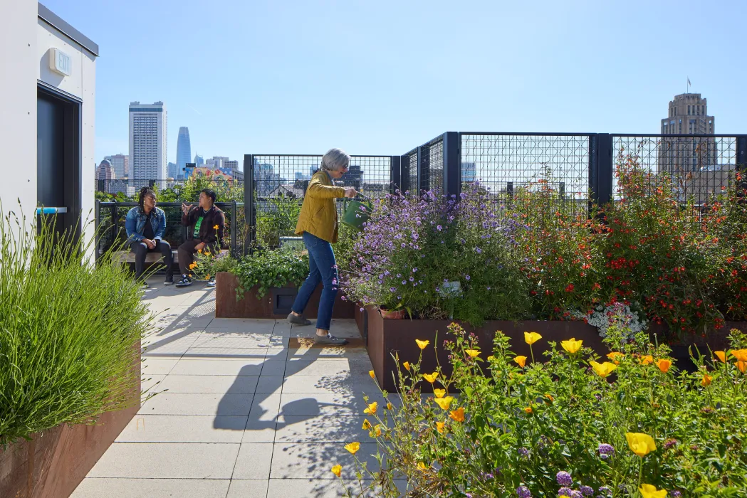 Residents gardening on the rooftop garden at Interior view of a unit at 555 Larkin in San Francisco.