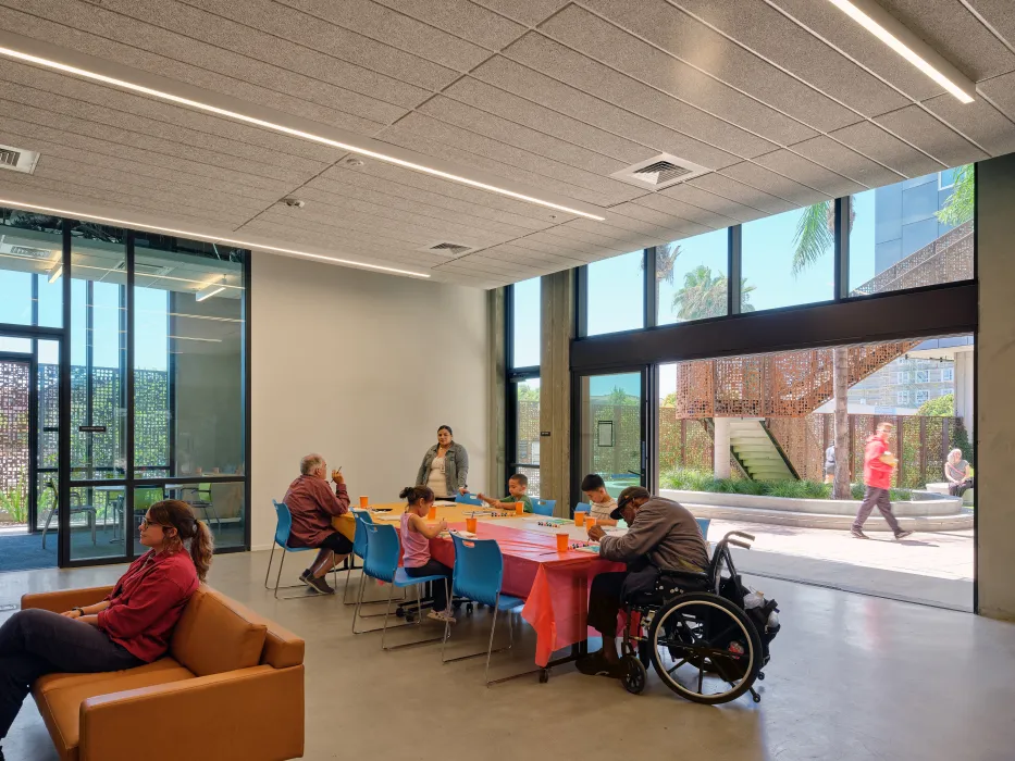 Community room flowing out to the courtyard at Sango Court.