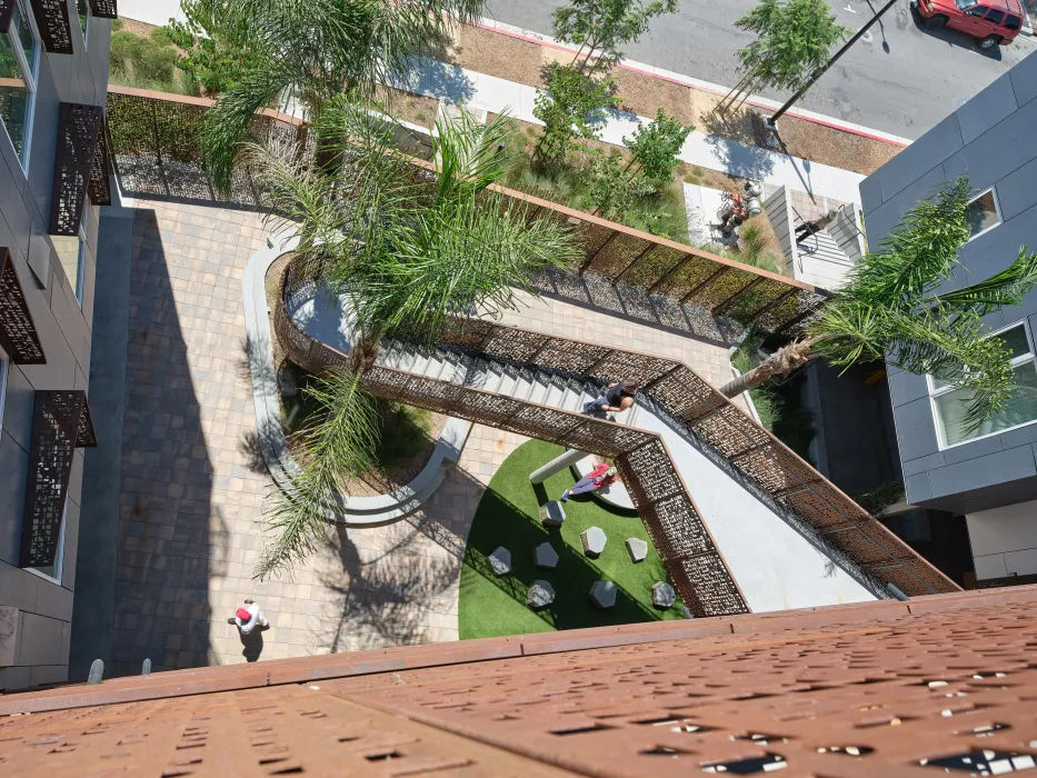 Looking down at the entry courtyard to from the open-air stair at Sango Court.