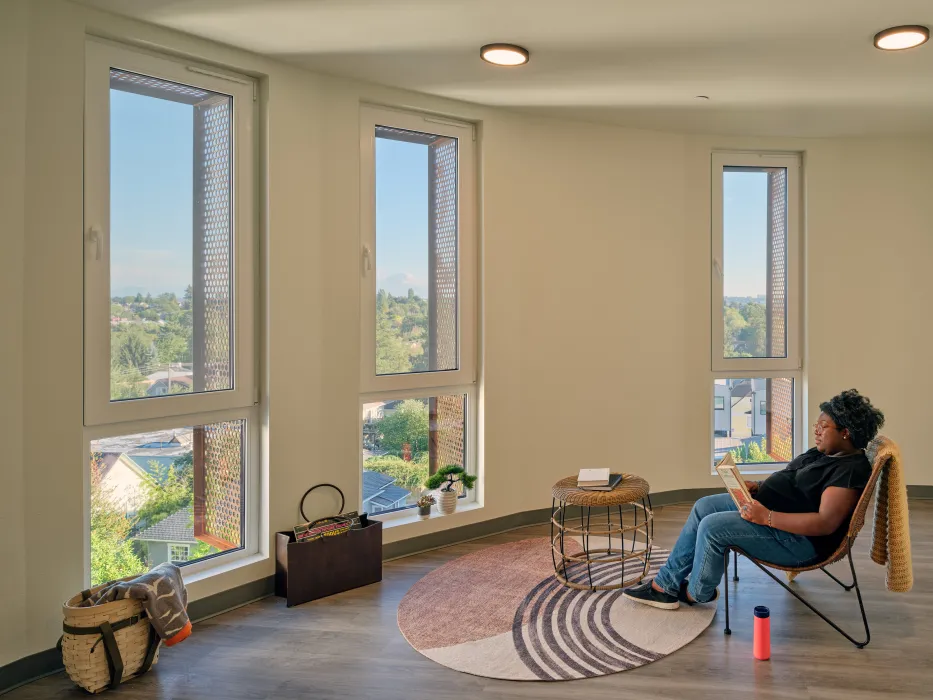 Resident sitting in her home at Africatown Plaza in Seattle.