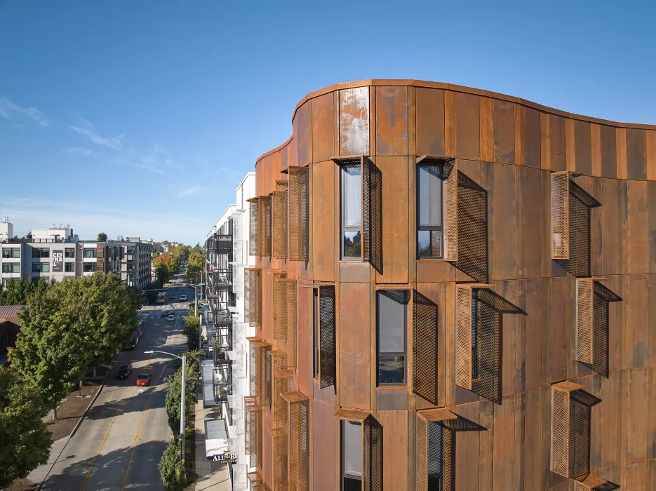 Detail view of the weathered steel facade and curve of Africatown Plaza in Seattle.