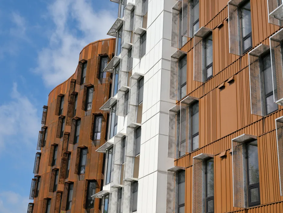 Detail view of the weathered steel facade of Africatown Plaza in Seattle.