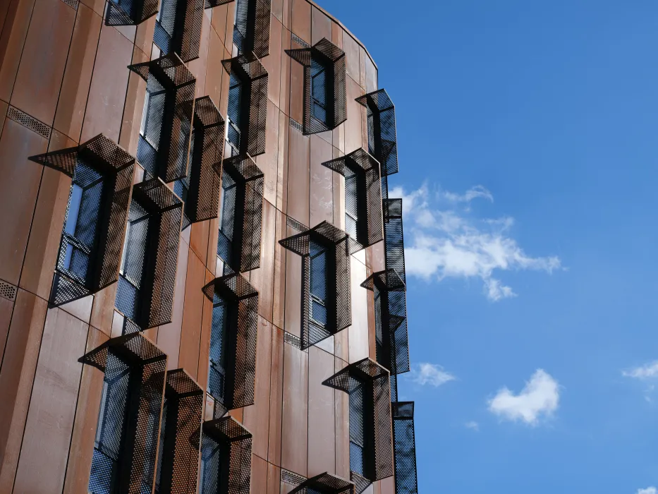 Detail view of the weathered steel facade of Africatown Plaza in Seattle.