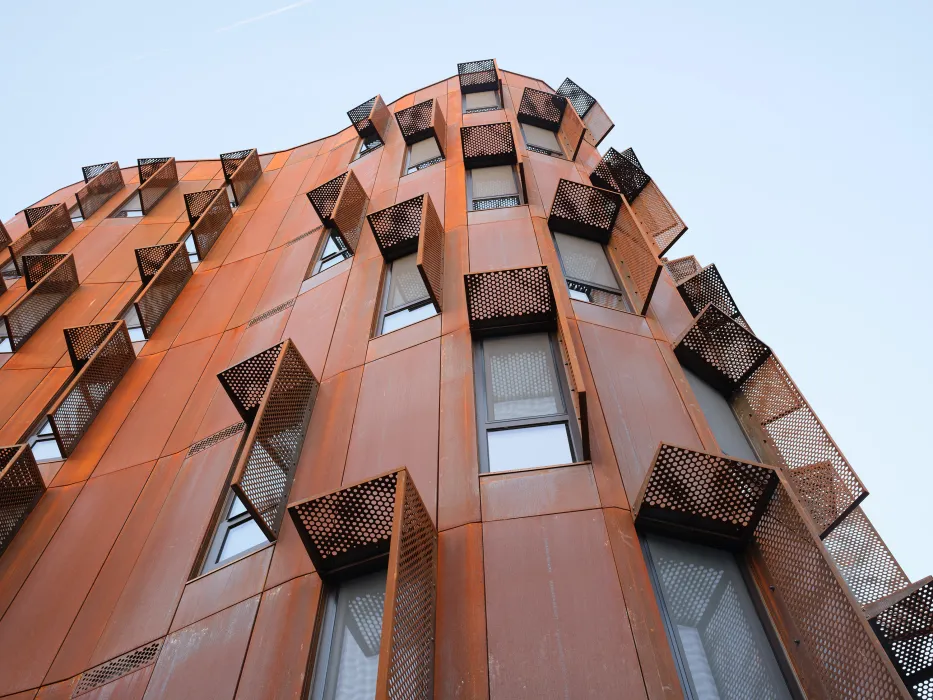 Detailed view of the weathered steel and windows at Africatown Plaza in Seattle.